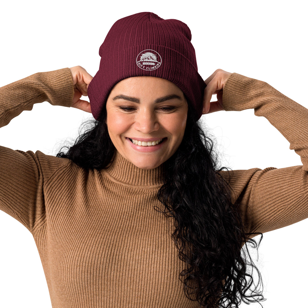 Woman in burgundy beanie smiling