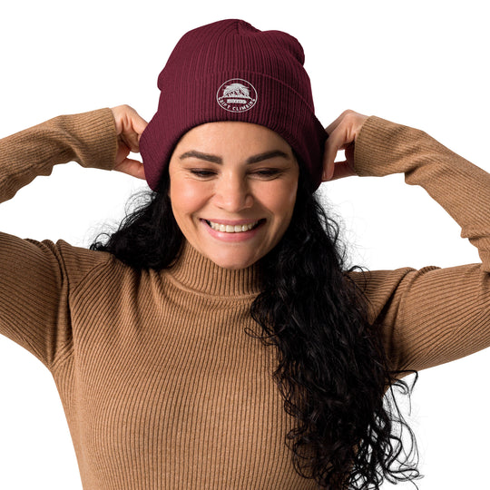 Woman in burgundy beanie smiling