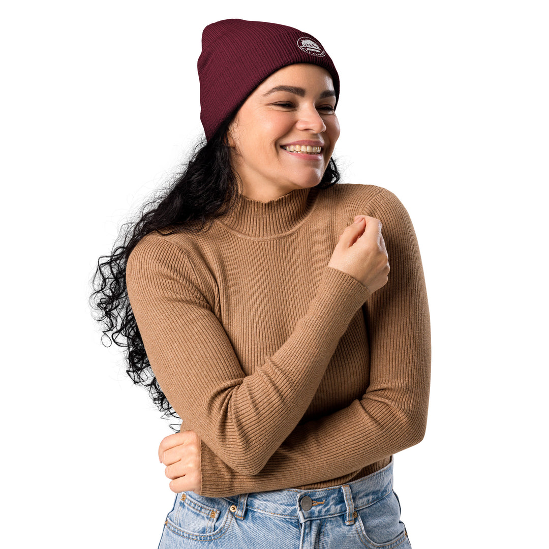 Woman in burgundy beanie smiling sideways